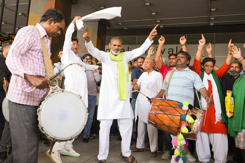 People gather to welcome wrestler Vinesh Phogat at IGI airport, in New Delhi